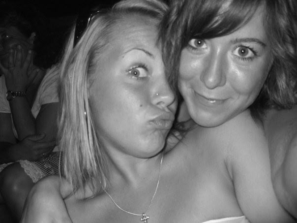 Lauren smiling with a friend in a black-and-white photograph