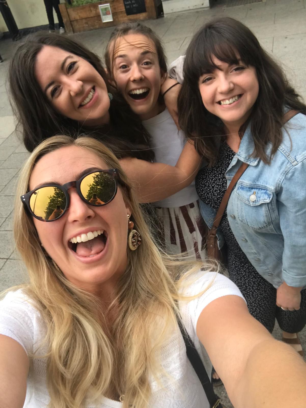 Lauren smiling with friends in a group selfie