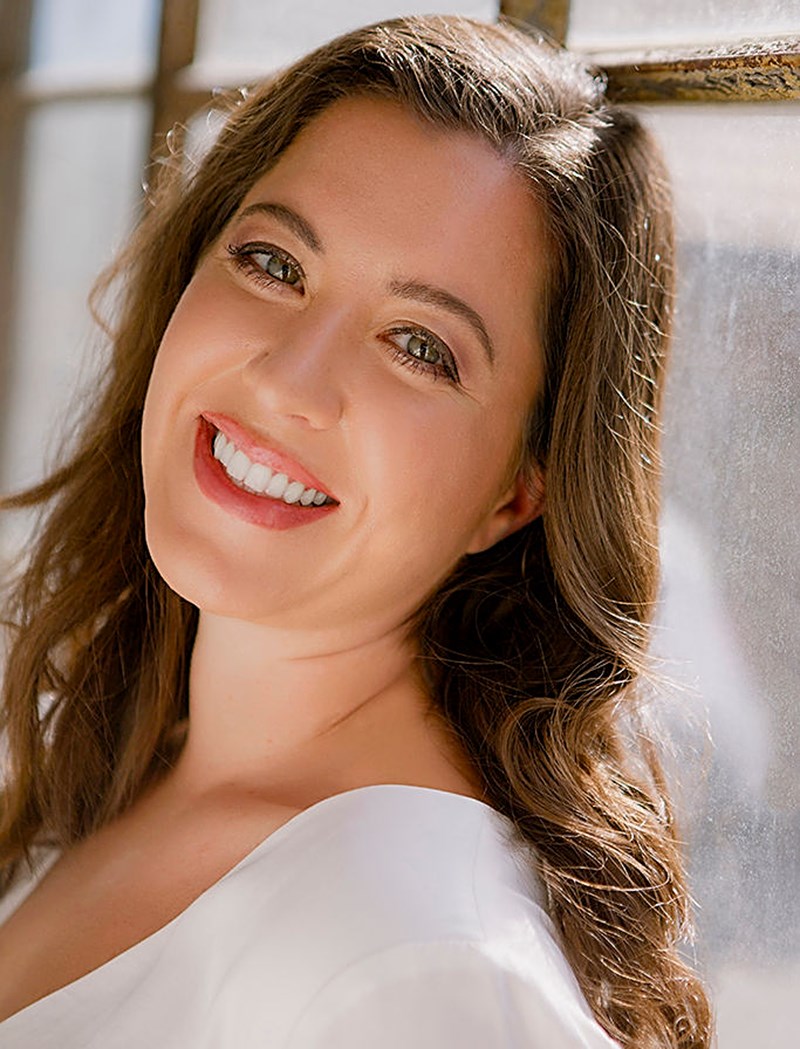 Lauren smiling by a window