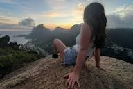 Lauren sitting on a rock looking over the landscape